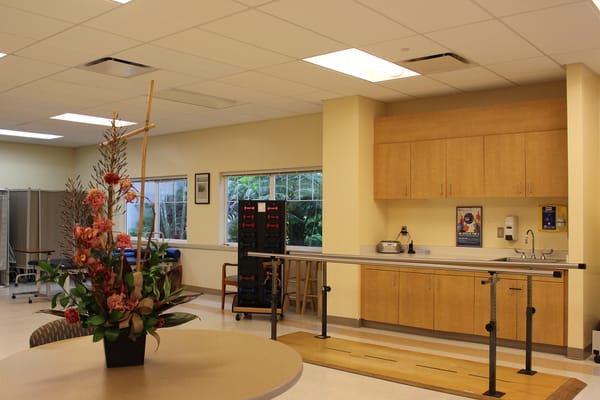 Rehabilitation room with exercise equipment and flowers