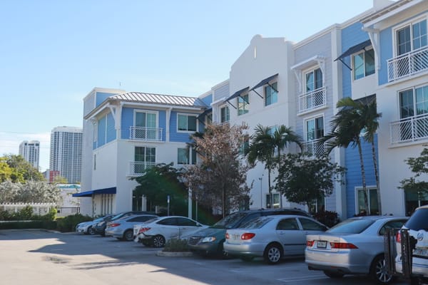 Exterior view of Father Marquess-Barry Apartments with parked cars
