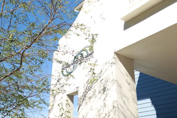 Exterior view of Father Marquess-Barry Apartments sign