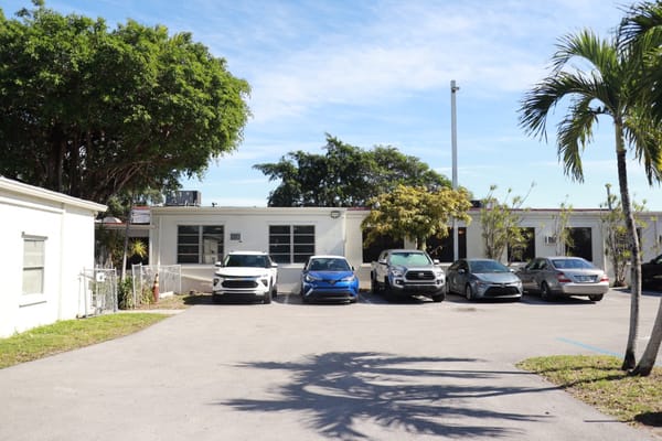 Exterior view of the facility with parked cars