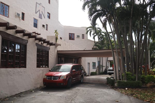 Entrance of Miami Springs Nursing and Rehab Center with vehicles