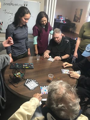 Residents playing bingo in a communal activity room