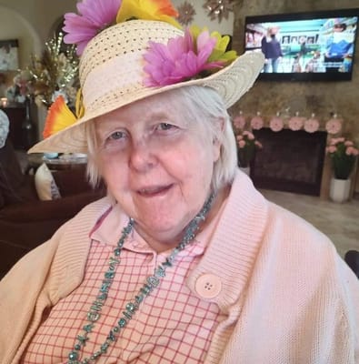 Resident with a decorated hat in a common area