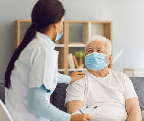 Caregiver interacting with senior in a warm environment