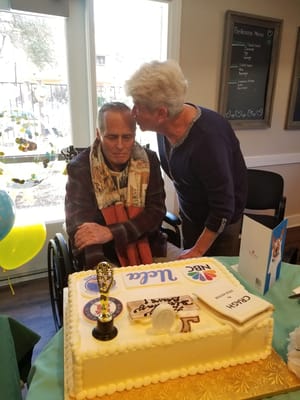 Resident celebrating with a birthday cake surrounded by decorations