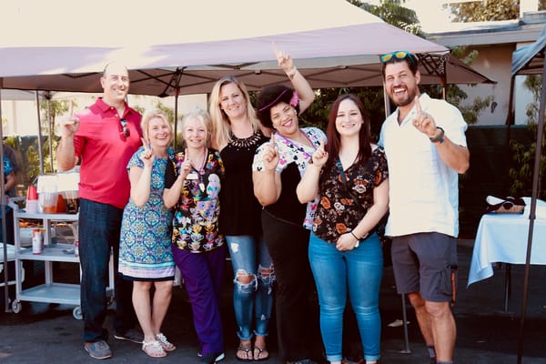 Staff and residents celebrating outdoors at an event