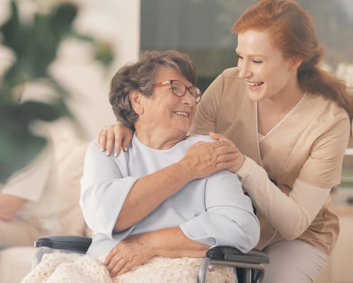 A caregiver and resident sharing a joyful moment