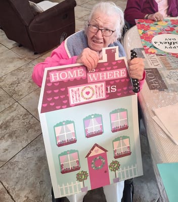 Resident participating in an activity holding a sign