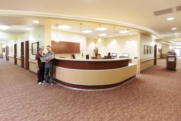 Reception area with staff and residents interacting