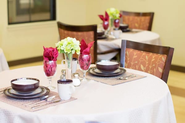 Dining setup with dishes and flowers on the table