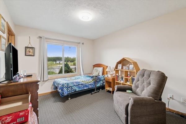 Cozy resident room with a bed and bookshelf