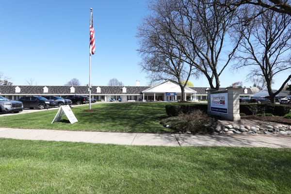 Exterior view of American House Dearborn Heights with flag
