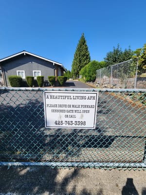 Exterior view of A Beautiful Living AFH with a sign