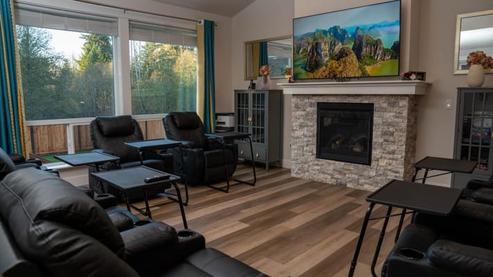 Cozy lounge area with recliners and a TV