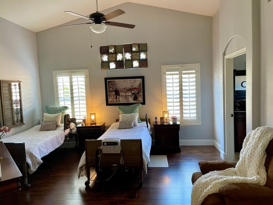 A shared room with two beds and a seating area