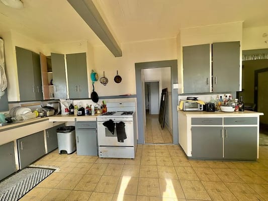 Interior view of a kitchen with cabinets and appliances