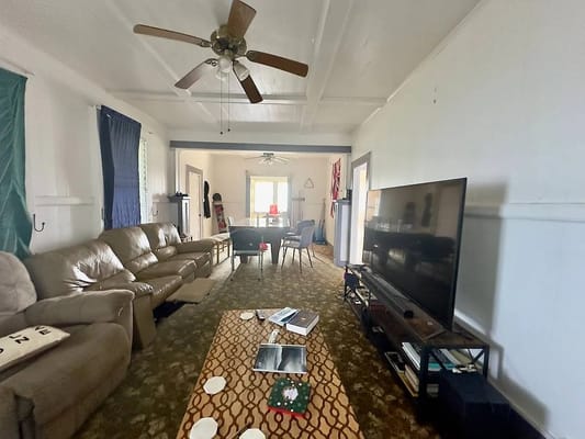 Cozy living room with a large TV and seating area