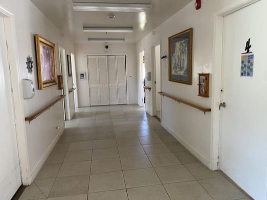 Well-lit hallway with artwork and railing