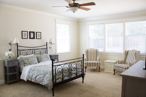 Brightly lit resident room with a bed and seating area