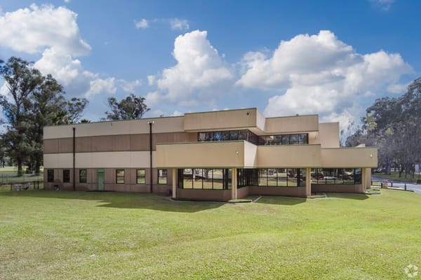 Exterior view of a modern assisted living facility surrounded by grass