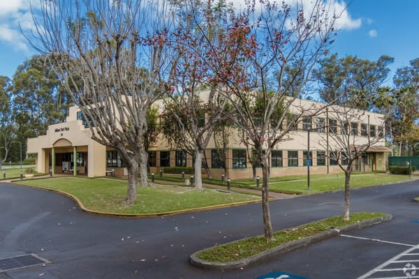 Exterior view of the assisted living facility with trees