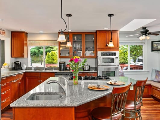 A modern kitchen with flowers and food on the counter