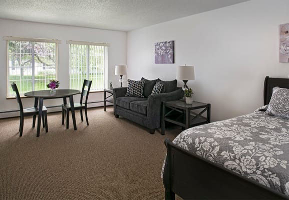 Cozy resident room with seating and natural light