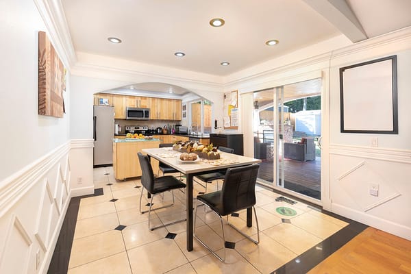 Bright dining area with a table and kitchen view