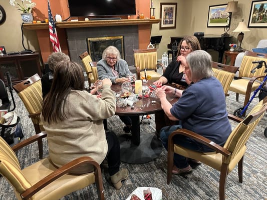 Residents engaged in a craft activity in a common area