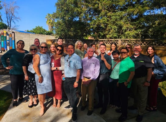Group photo of staff members in a garden area