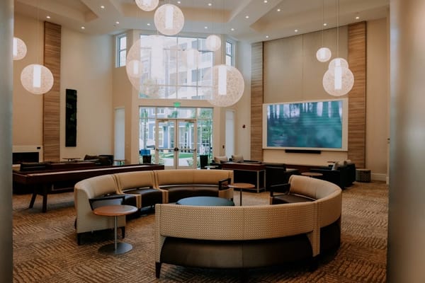 Spacious lounge area with modern seating and large windows.