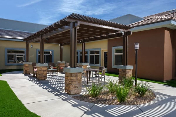Outdoor patio area with seating and landscaping
