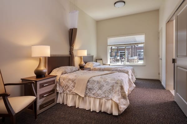 Cozy twin bedroom in a senior living facility