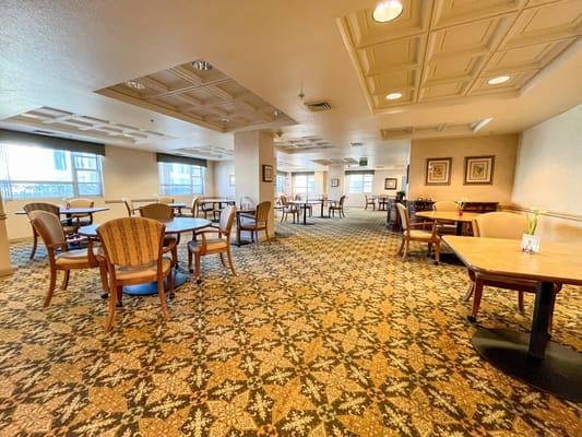 Dining area with tables and chairs in the facility