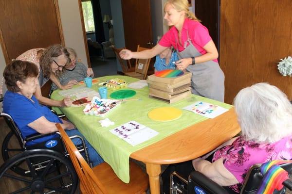 Residents participating in an art activity with staff