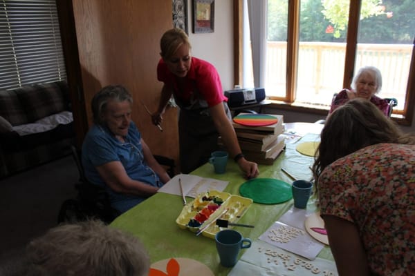 Residents engaged in a creative activity indoors