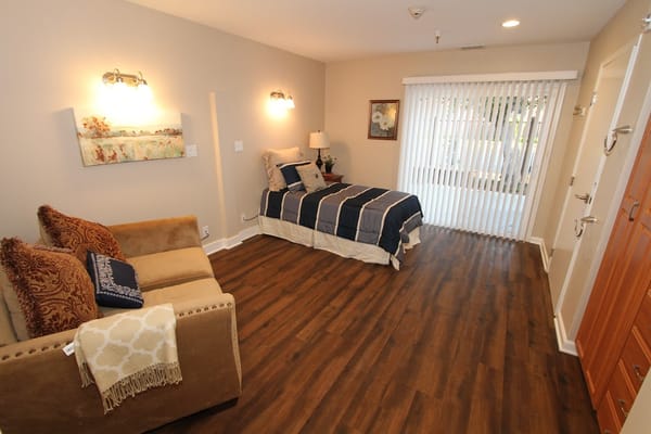 Cozy resident room with a bed and seating area