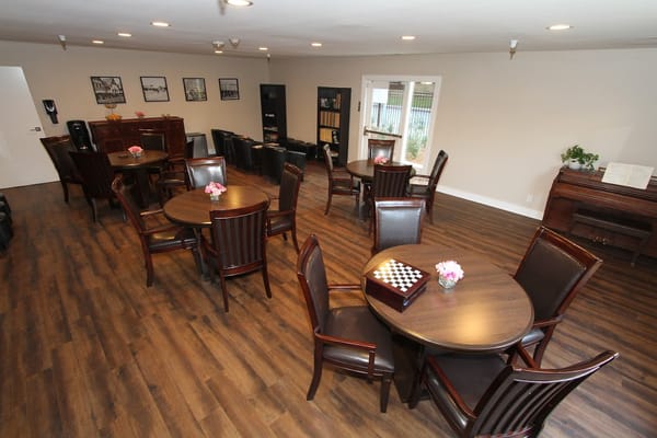 Common area with seating and tables for residents