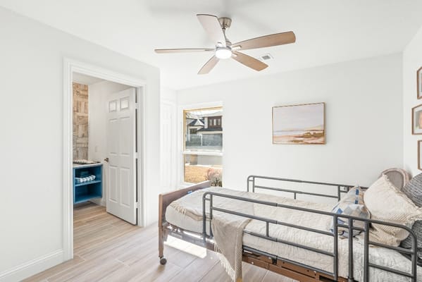 Brightly lit private room with a bed and window