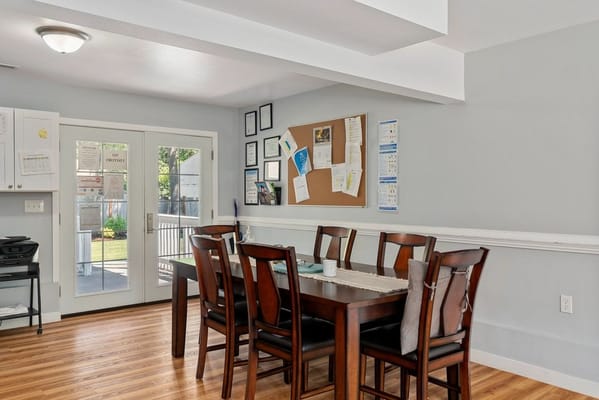 Interior common area with a dining table and bulletin board