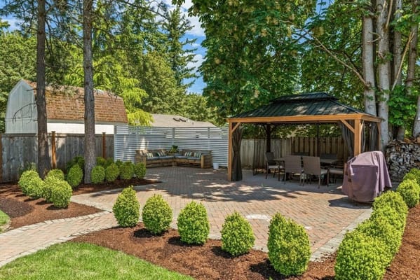 Outdoor patio area with seating and greenery