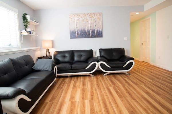 Modern lounge area with black sofas and artwork