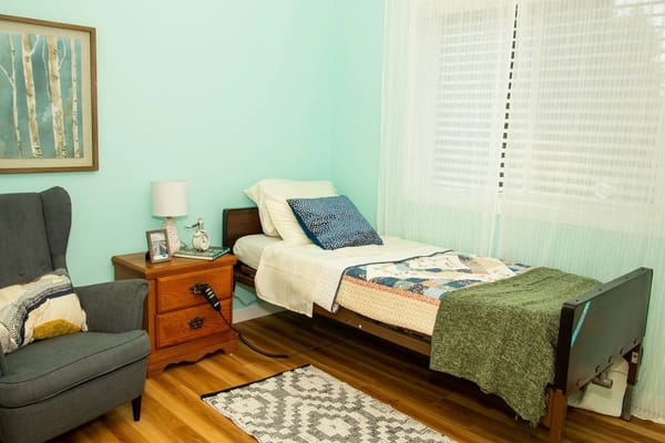 Cozy resident bedroom with a bed and armchair