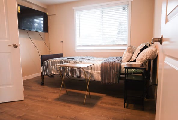 Private resident room with a bed and TV