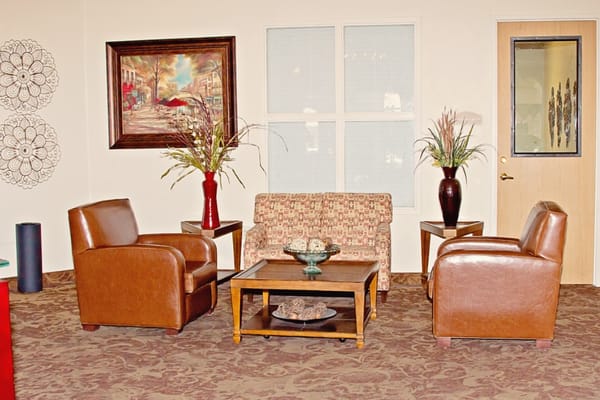 A cozy sitting area with chairs and a table
