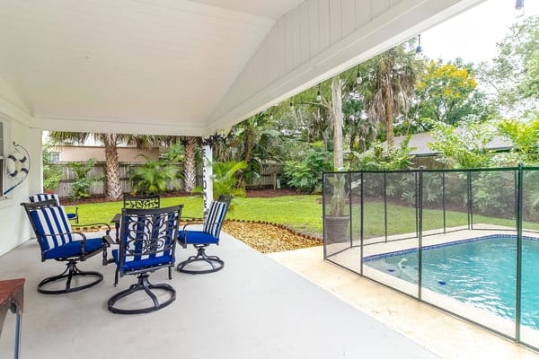 Outdoor seating area with pool and garden view