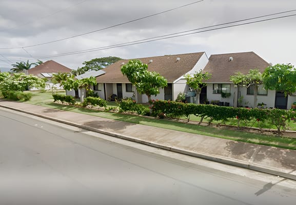 Exterior view of a senior living facility with landscaping