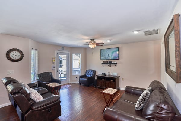 Cozy interior common area with seating and TV