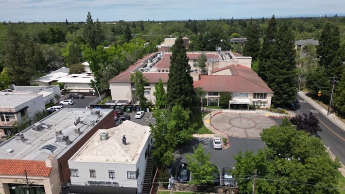 Aerial view of an assisted living facility surrounded by trees