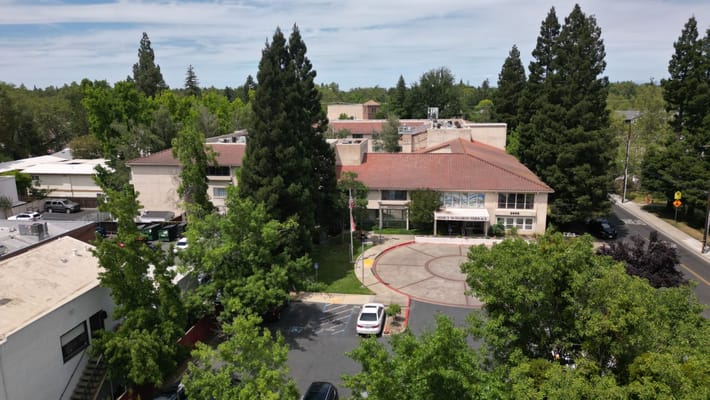Aerial view of the facility building and surrounding trees